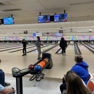 A group of people bowling.