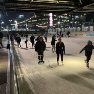A group of people ice skating.